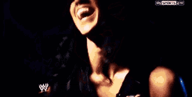 a close up of a person 's mouth with a w logo on the bottom right corner .