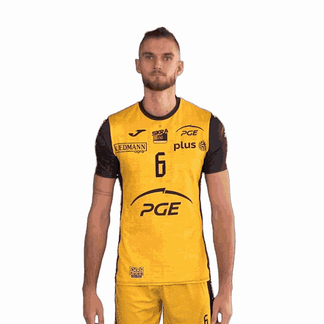 a man is wearing a yellow and black pge plus shirt