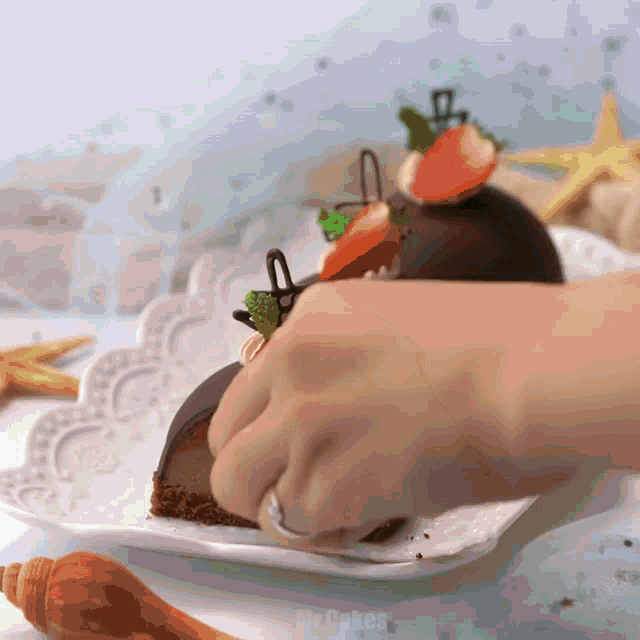 a person is putting a piece of cake on a plate that says cakes
