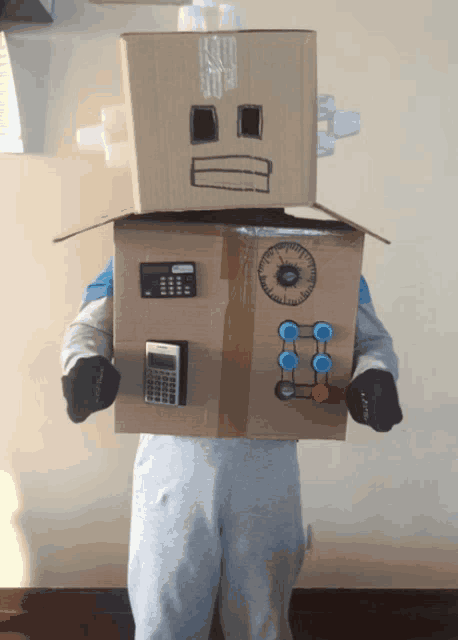 a person wearing a cardboard robot costume with a calculator and buttons