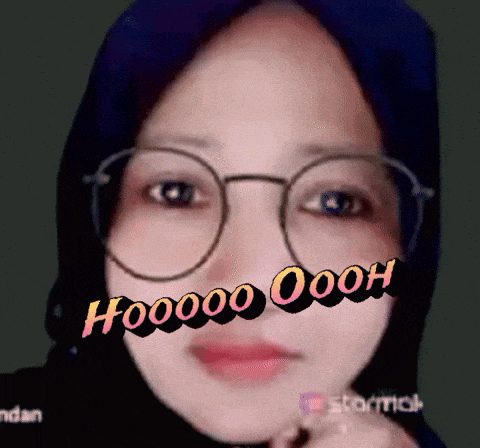 a woman wearing glasses and a scarf says hooooo ooh