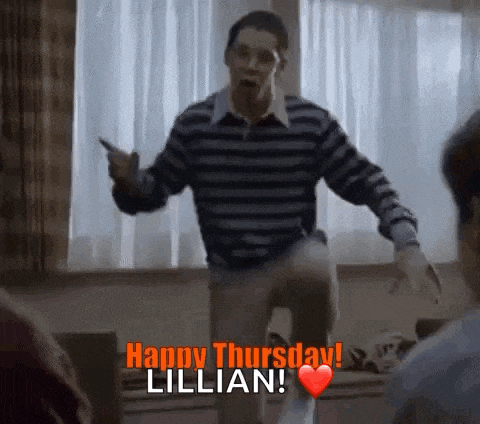 a man in a striped sweater is dancing in a living room while holding a cell phone .