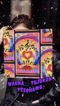 a woman in a black jacket is holding a colorful painting in front of her face