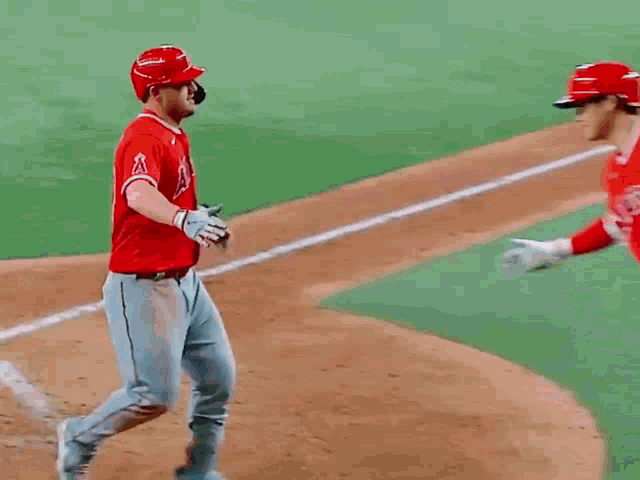 two baseball players one of whom is wearing the number 27