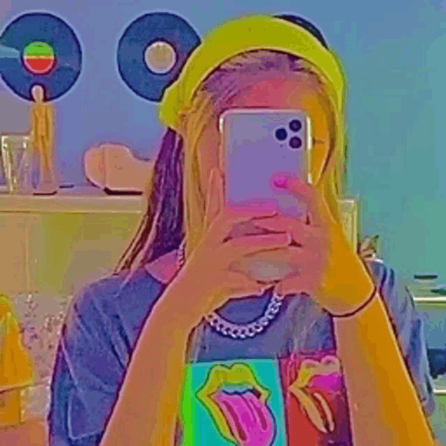 a girl is taking a picture of herself with her phone .