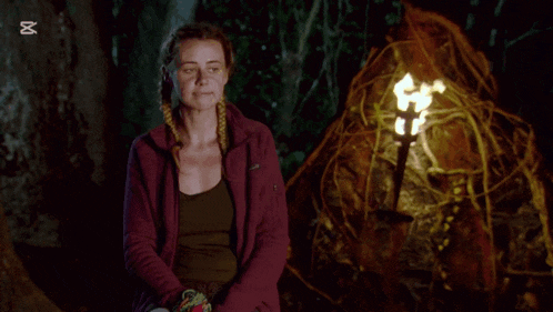 a woman is sitting in front of a torch with the capcut logo above her