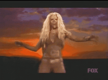 a woman in a bikini is dancing in front of a fox sign