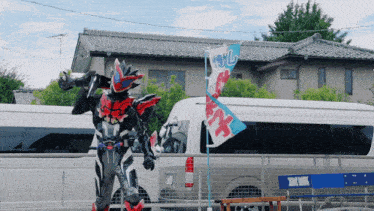 a man in a superhero costume stands in front of a van with a flag that says ' x ' on it