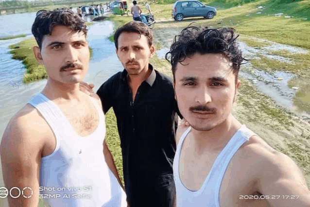 three men are posing for a picture with a shot on vivo s1 camera