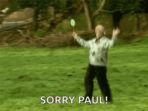 a man is holding a badminton racket and says sorry paul .