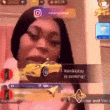 a woman is playing a video game with a yellow car in the background