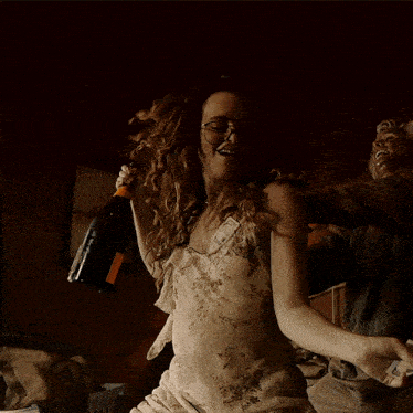 a woman in a dirty dress holds a bottle of champagne in her hand