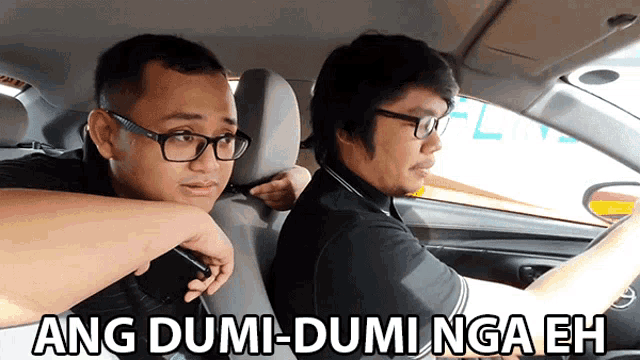 two men in a car with ang dumi-dumi nga eh written in white