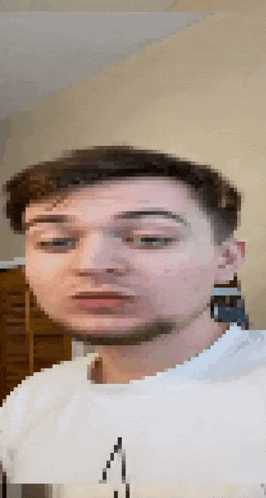 a pixelated image of a man 's face with a beard and a white shirt .