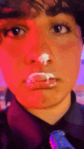 a close up of a person 's face with white powder on their face