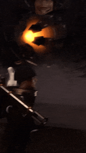 a person holding a gun in a dark room with a light coming out of their mouth