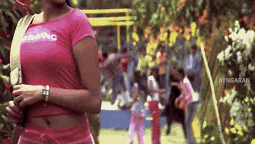 a woman in a pink shirt that says ayngaran on the bottom