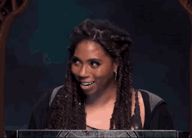 a woman with dreadlocks is smiling with the words have you seen the ocean behind her
