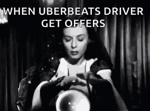 a black and white photo of a woman holding a crystal ball in her hands .