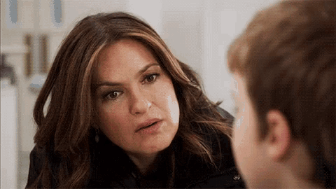 a woman is talking to a young boy who is looking at her