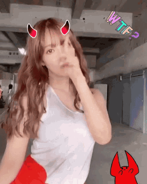 a woman in a white tank top has devil horns on her head and the word wtf3 on the bottom