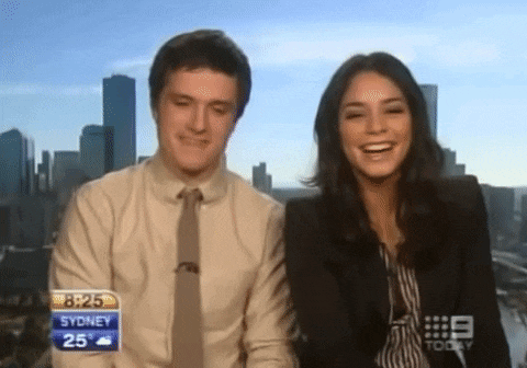 a man and a woman are standing in front of a sign that says 8:25 sydney 25 degrees
