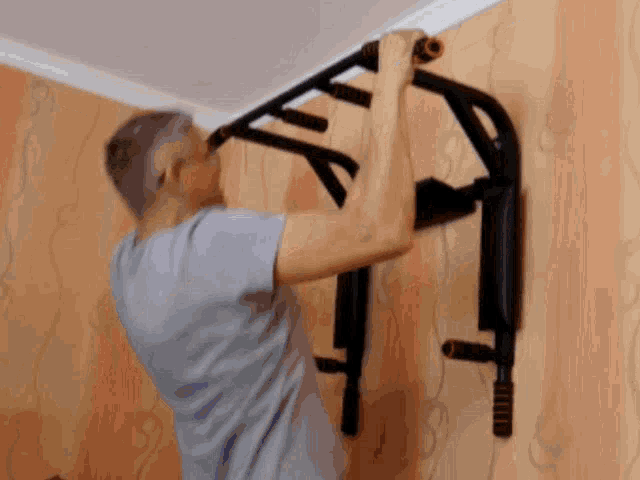 a man is doing a pull up on a bar
