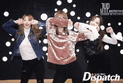 a group of girls are dancing in front of a sign that says dispatch