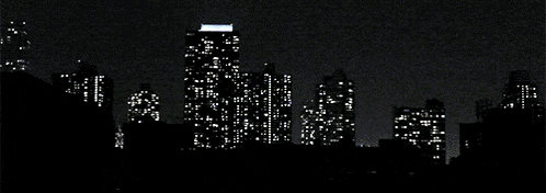 a pixelated image of a city skyline with a few buildings lit up at night