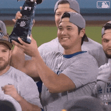 a baseball player is holding up a trophy that says world series champions