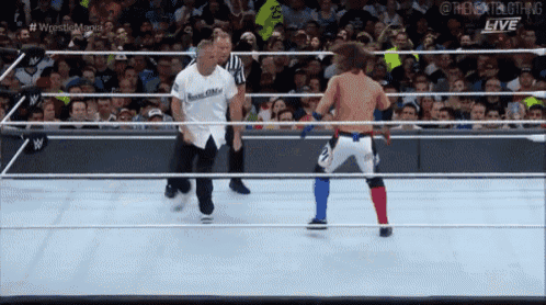 a wrestler in a white shirt that says best life is in a wrestling ring