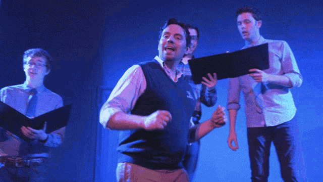 a man wearing a blue vest with the word nautica on it