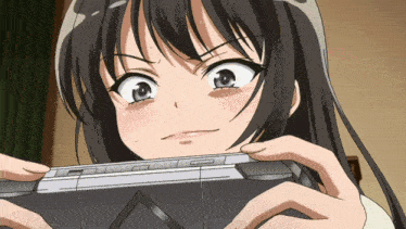 a girl is holding a video game controller and making a face