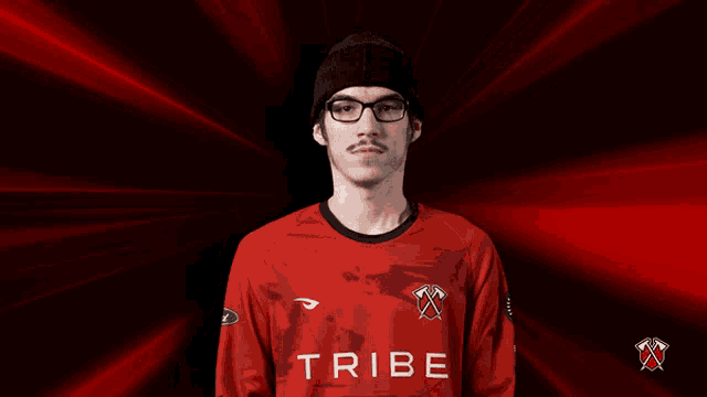 a man wearing glasses and a red shirt that says tribe