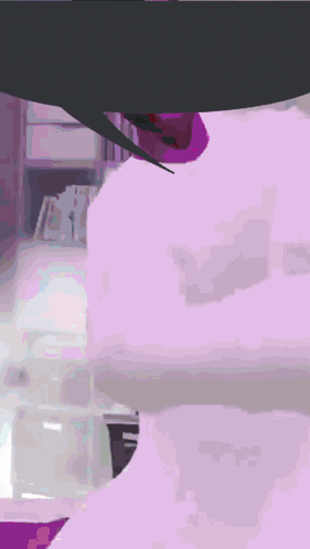 a person is laying on a bed with a purple and white background