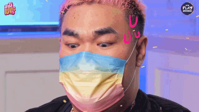 a man wearing a face mask with the word play on the bottom left
