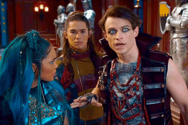 a group of people are standing next to each other and one of them is wearing blue hair