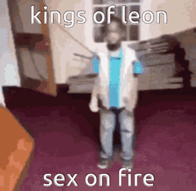 a child is standing in a room with the words kings of leon sex on fire