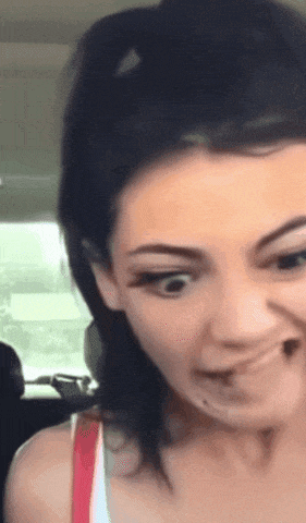 a close up of a woman making a face with her mouth open