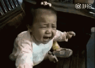 a baby is crying while sitting on a chair in a chair .