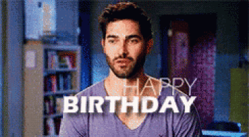 a man in a purple shirt with the words happy birthday behind him