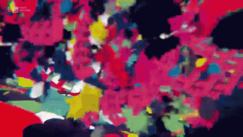 a colorful painting with a black background and red , yellow , and blue spots .