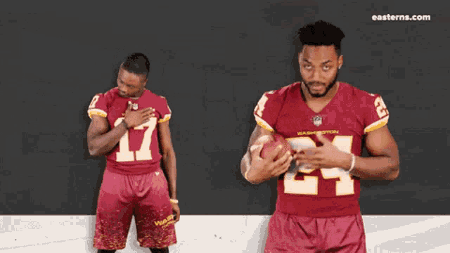 a man in a washington football jersey is holding a football