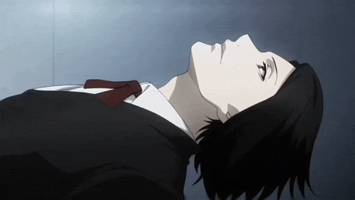 a man in a suit and tie laying down with his head up