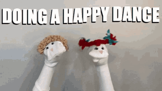two sock puppets wearing hats with the words doing a happy dance behind them