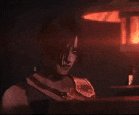 a woman in a dark room with a red light behind her .