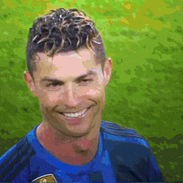 a man with curly hair is wearing a blue shirt and smiling .