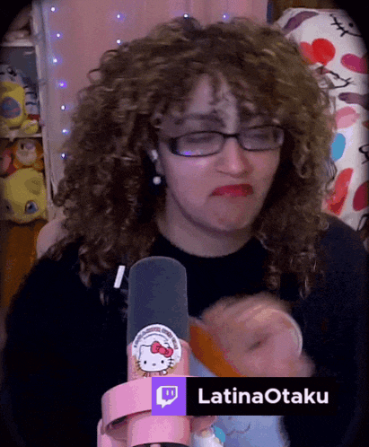 a woman with curly hair is wearing glasses and a hello kitty headband