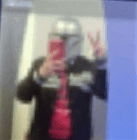 a blurry picture of a person taking a selfie with a cell phone