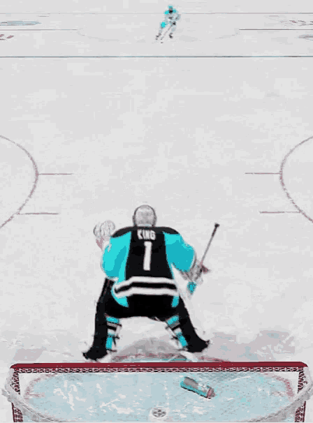 a hockey goalie with the number 1 on his jersey makes a save